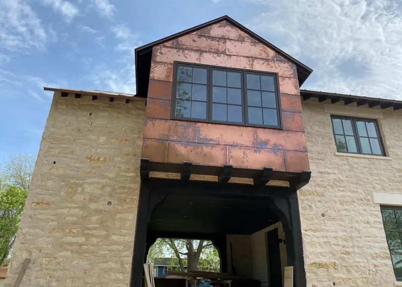 Copper metal panel facade on a stone building for Skylight Installation in Homestead Meadows South