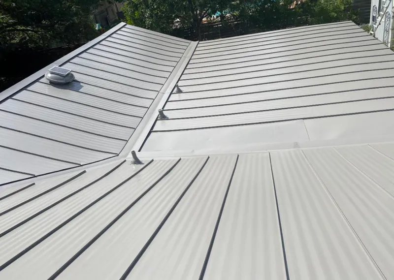 Solar attic fan installed on a metal roof for Roof Ventilation in Homestead Meadows South