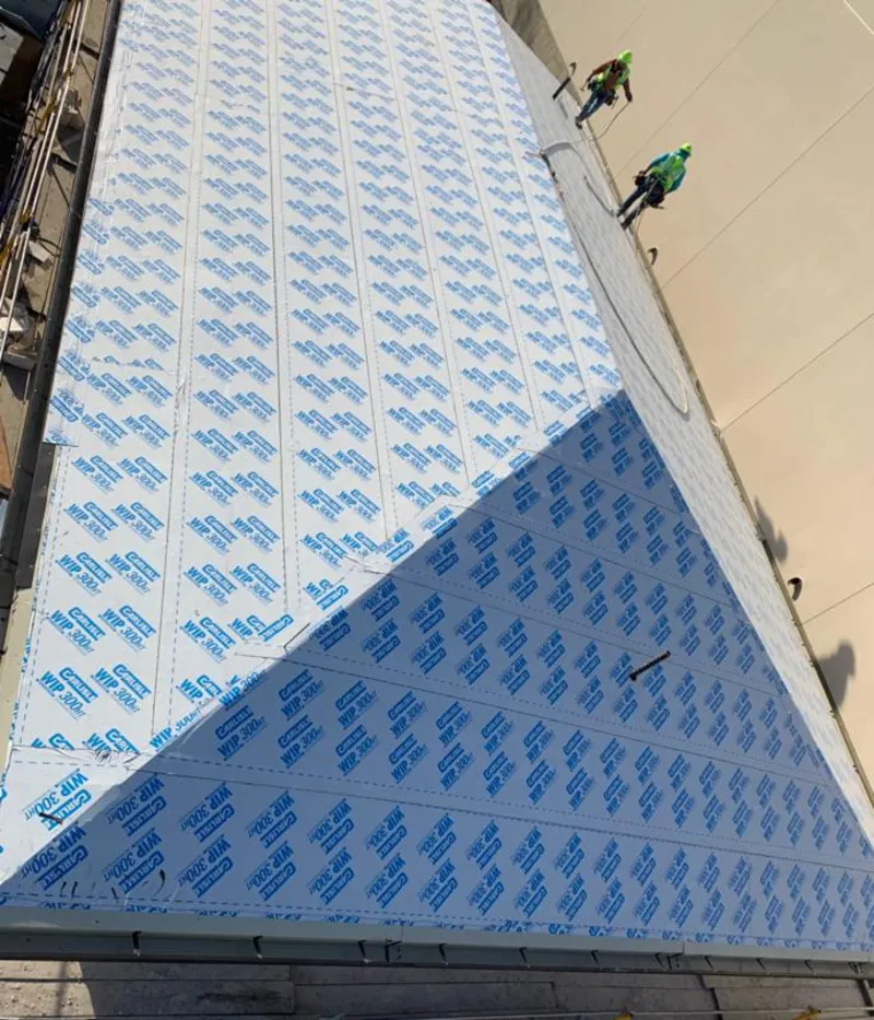 Professional roofers installing underlayment on a metal roof in Homestead Meadows South